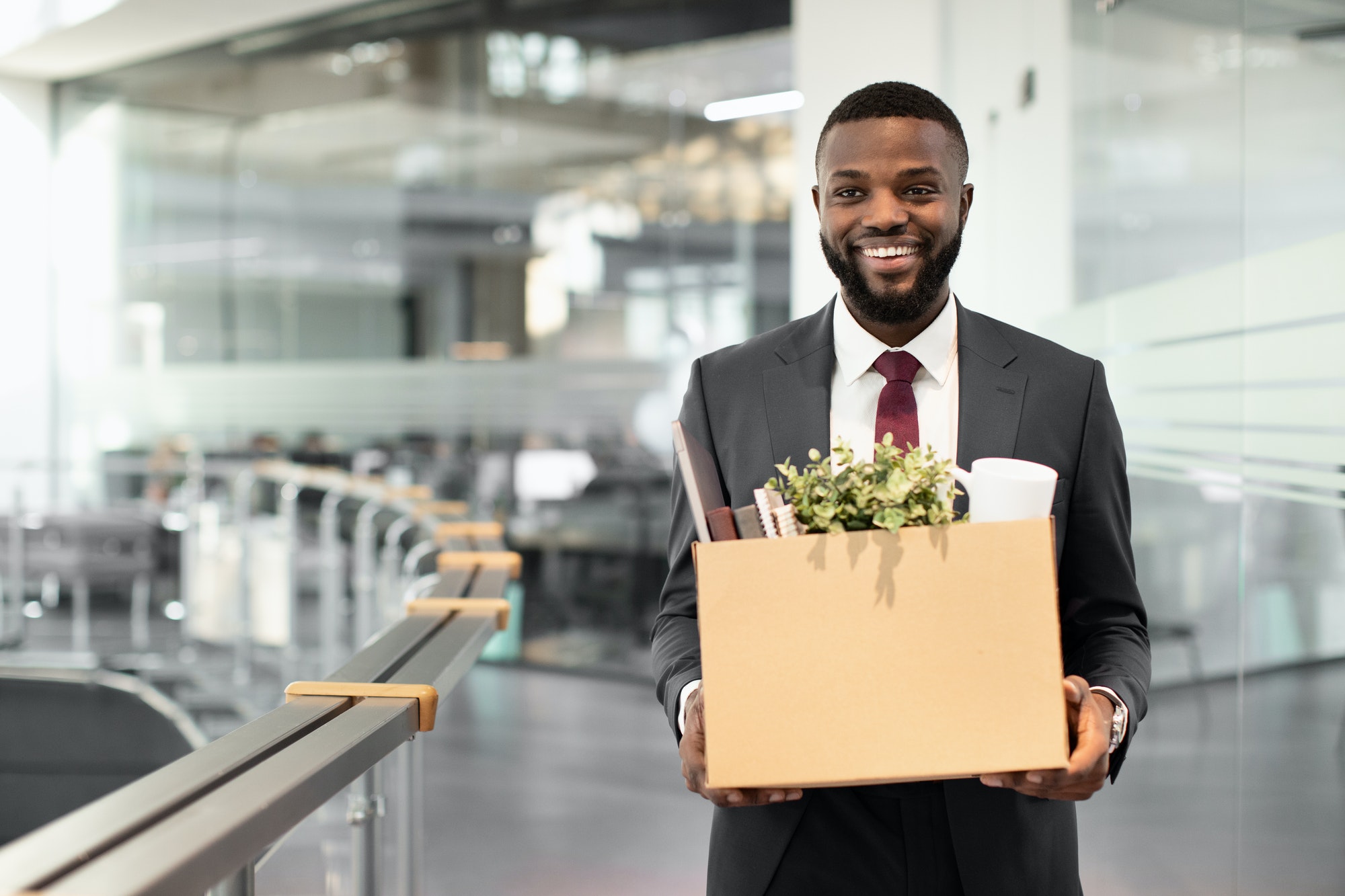 Happy african american young man employee with working stuff