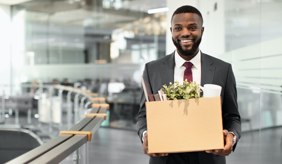 Happy african american young man employee with working stuff